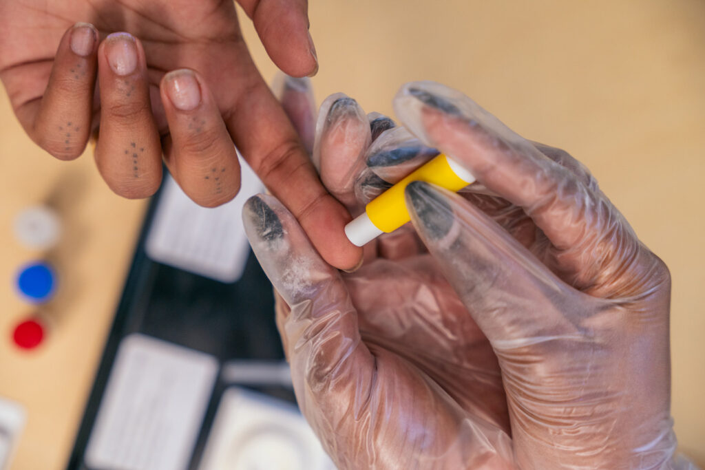 Close-up of someone doing a finger-prick HIV test